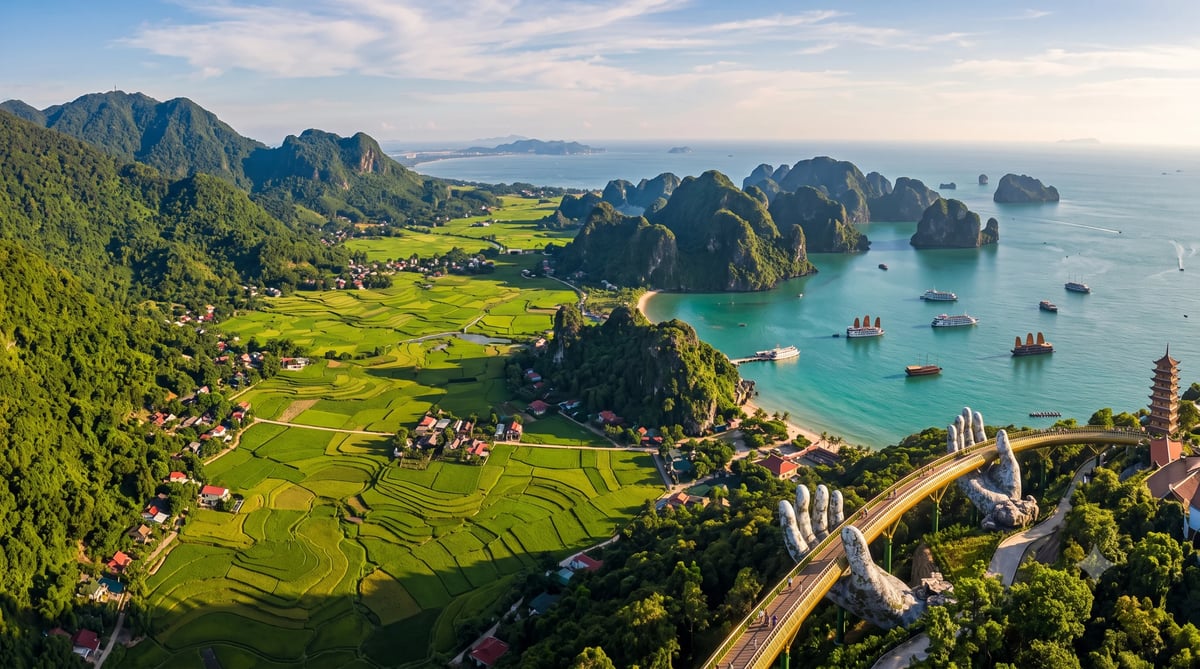 Aerial view of Halong Bay with limestone karsts, turquoise waters, green valley, villages, and coastal bridge in Vietnam